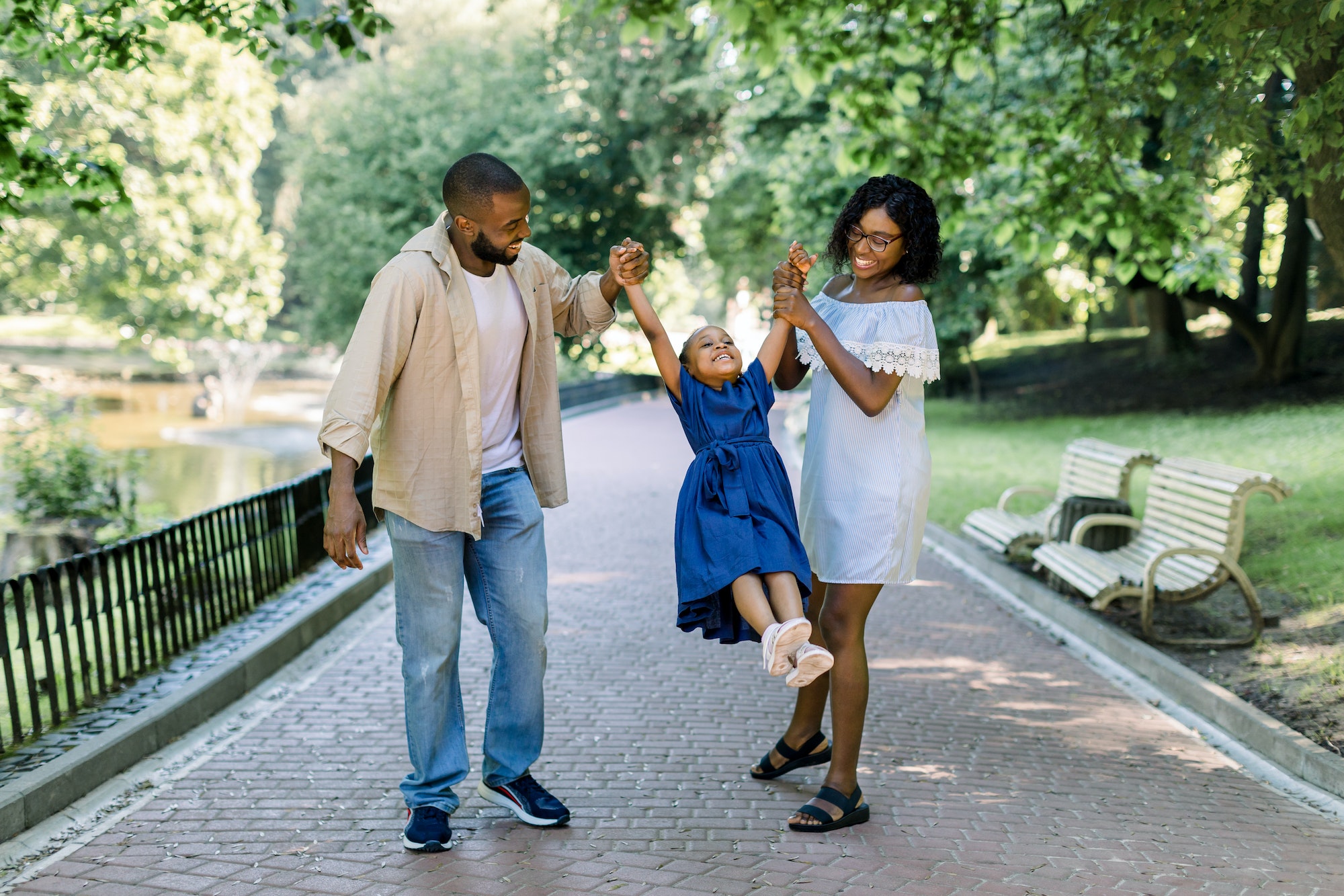 Happy African family in the park in the summer sunny evening.